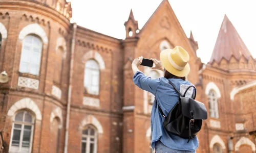 stylish-traveller-with-hat-taking-pictures-holiday